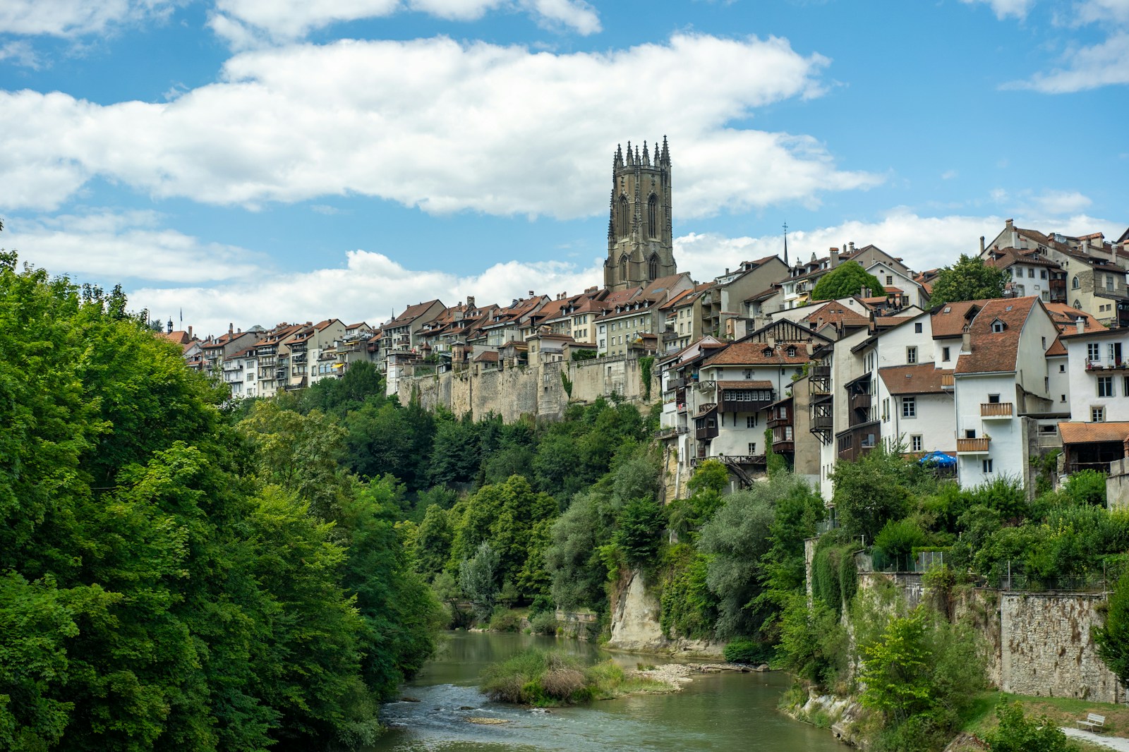 Photo by Alin Andersen a town with a river running through it